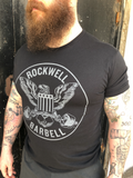 The Rockwell Barbell grey circle logo with eagle on front of black shirt.