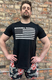 A person wearing a black t-shirt with the words "Rockwell Barbell Chicago, IL" and the USA flag. The design and text is in white, and the t-shirt is black.