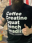 Close up of shirt with the words "Coffee Creatine Squat Bench Deadlift" in white letters on a black shirt, with "Rockwell Barbell" in white outlined letters at the bottom.